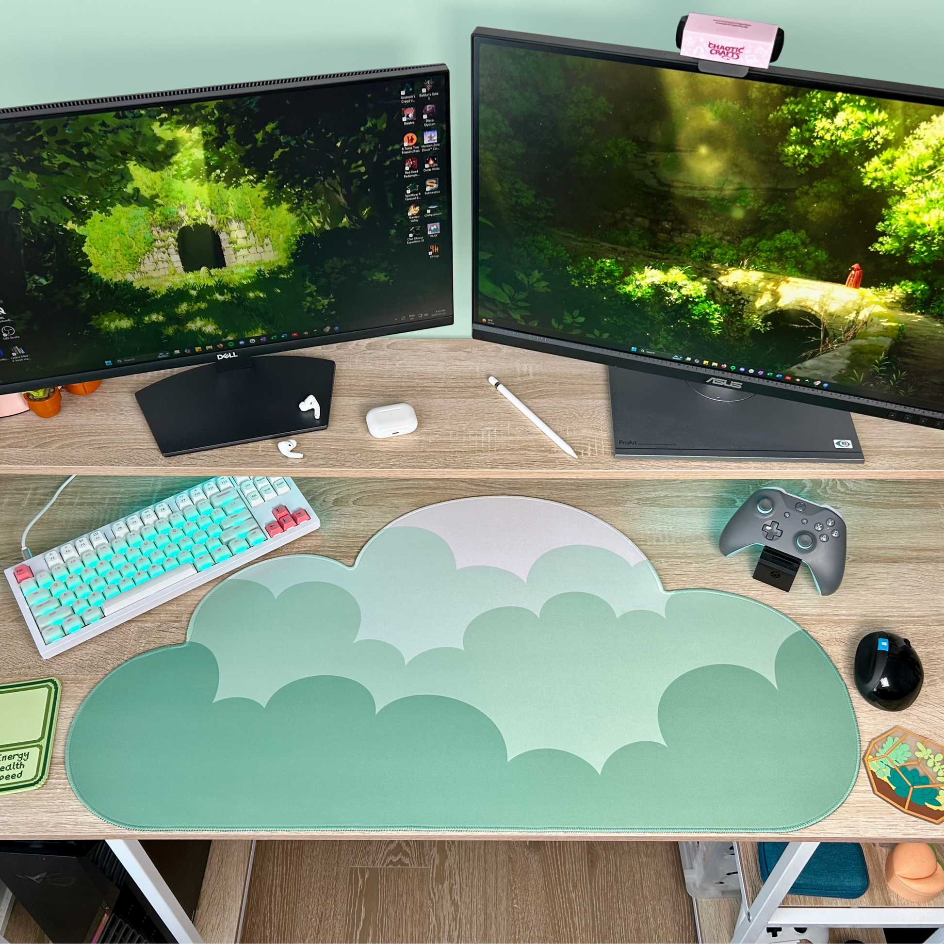 Desk setup with dual monitors, keyboard, mouse, and sage green ombre cloud-shaped mouse pad.